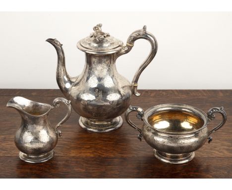 Matched Victorian silver three-piece tea set engraved with scrolling detail and family crest, with acanthus scroll capped han