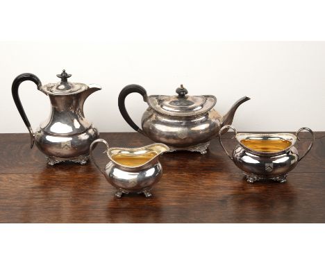 George V silver four piece tea setcomprising of a teapot, water pot, each with ebony handles, twin handled sucrier and a crea