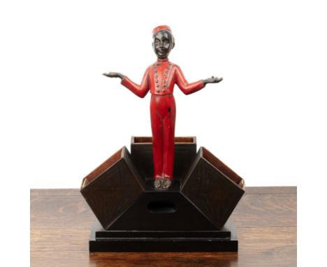 Art Deco cold painted bronze figure, of a bell boy in red clothing, the base with three wooden lined holders on stepped plint