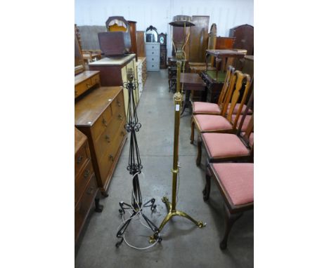 A telescopic brass standard lamp and a wrought iron standard lamp 