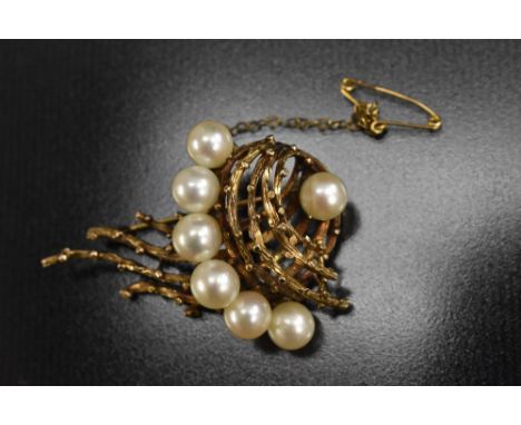 An unusual mid 20th century yellow metal and cultured pearl brooch, open arching naturalistic ally modelled multi section spi