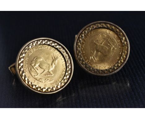 A pair of South African 1 Rand gold coin inset cufflinks. 1967, mounted in 9ct gold frame and folding action body, London 197