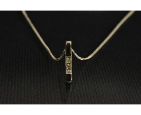 A contemporary diamond trilogy pendant, linear set with three princess cut square diamonds, total estimated diamond weight ap