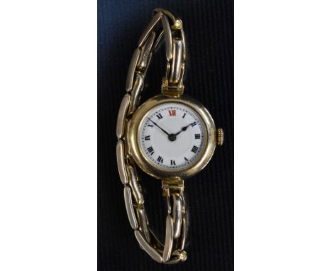 A ladies 9ct gold cased wristwatch, white enamel dial, bold Roman numerals, minute track, blued spade hands, Swiss 15 jewel m