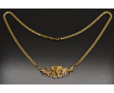 A novelty 18ct gold necklace, central cast section of African animals, Rhino, Giraffe, Bull and Cow Elephants, Lion, fancy li