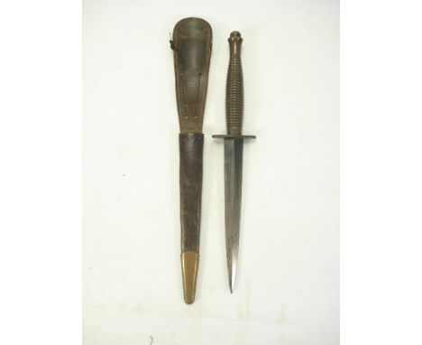 A Fairbairn Sykes fighting knife, 3rd pattern:, the double edged blade over hilt and one piece ribbed grip, stamped with broa