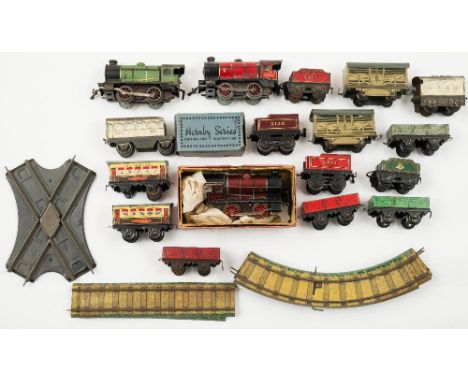 A collection of Hornby O gauge M1:, including three 0-4-0 tank engines, two Pullman passenger coaches, goods wagons and a sma