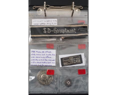 A collection of Third Rich insignia:, including a SS Officer's belt buckle with eagle and swastika emblem ,stamped 'RZM' to r