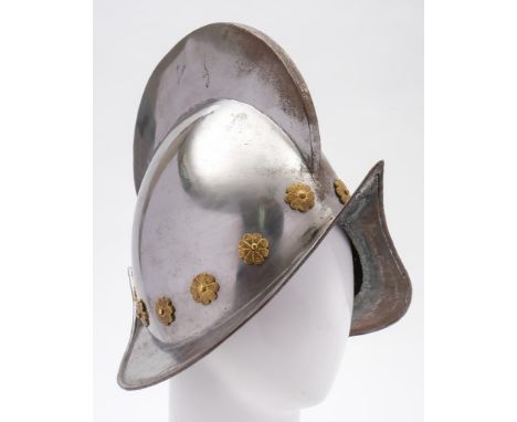 A reproduction Spanish morion helmet:,  20th century with high comb, plume holder, floral brass studs and upswept rim 30cm hi