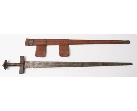 A North African Tuareg sword (Takuba):, the broad double edged blade with crescent stamps to each side, rectangular leather c