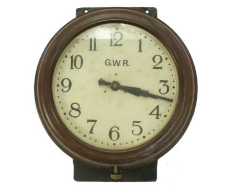 A G.W.R. Bakelite clock:, the white painted dial with Arabic numerals and marked 'GWR' in a brown circular case with  brass w