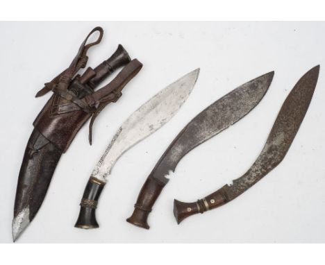 A group of four Kukri's:, of traditional form ,on in a leather scabbard with an associated WWII period brown leather frog sta