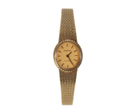 A TISSOT 14CT GOLD LADY'S BRACELET WATCH with quartz movement, the gold dial with gold baton numerals and dark blue steel han