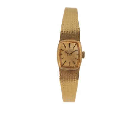 AN OMEGA 18CT GOLD LADY'S BRACELET  WATCH with manual wind movement, the gold dial with gold baton numerals and gold hands, n