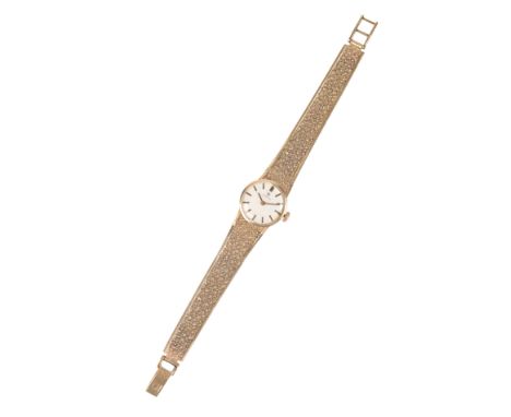 AN OMEGA  9CT GOLD LADY'S BRACELET WATCH with manual wind movement, the silver dial with gold baton numerals and gold hands, 