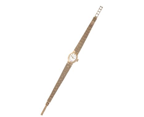 A ROTARY 9CT GOLD LADY'S  BRACELET WATCH with manual wind movement, the silver dial with gold baton numerals and hands, the c