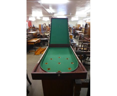 A Victorian mahogany bagatelle board and cues 