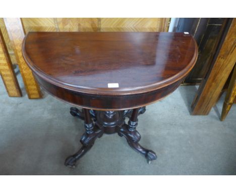 A Victorian carved mahogany demi line fold-over card table 