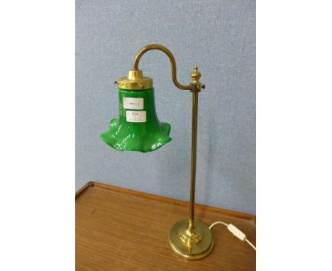 A brass desk lamp with green glass shade 