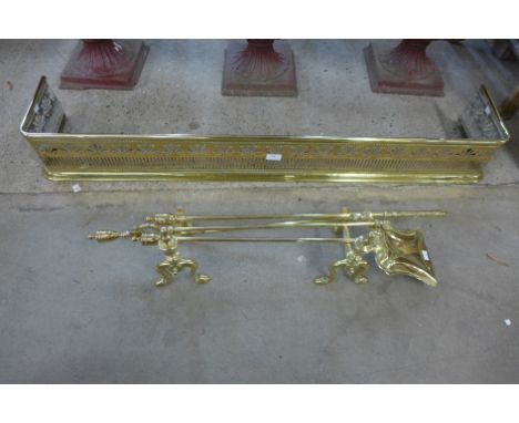 A 19th Century brass pierced fender, fire irons and andirons 