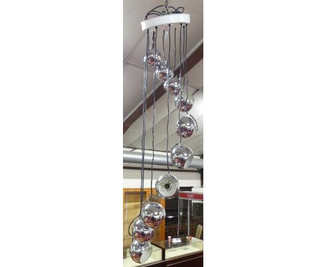 A 1960s ten-light cascading ceiling light, having domed polished chrome shades, with white painted metal affixing ceiling mou