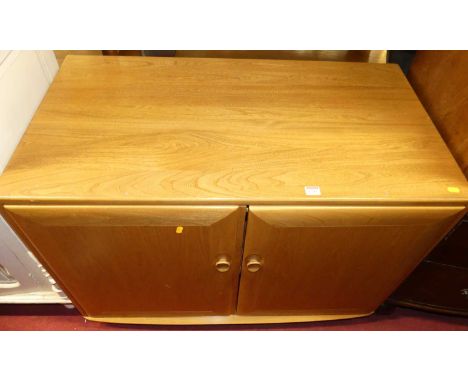 A contemporary Ercol blond elm double door media unit, width 104cm
