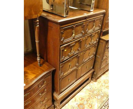 An antique joined oak chest of two short over three long graduated drawers, raised on later squat bobbin turned stand, the dr