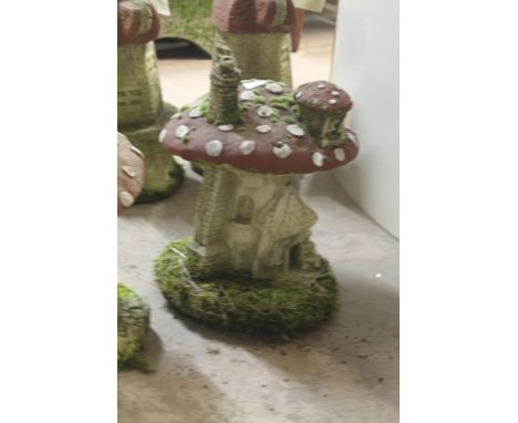 A LARGE GARDEN ORNAMENT OF A MUSHROOM HOUSE