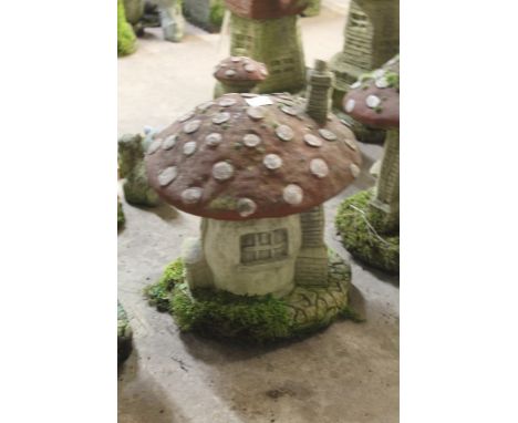 A LARGE GARDEN ORNAMENT OF A MUSHROOM HOUSE