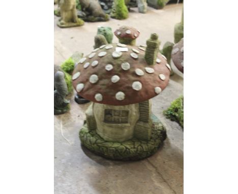 A LARGE GARDEN ORNAMENT OF A MUSHROOM HOUSE
