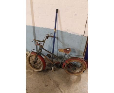 A VINTAGE CHILD'S BIKE TOGETHER WITH A POGO STICK 