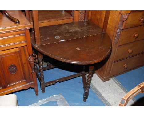 A 1940's oval Oak Drop-leaf Gateleg Dining Table with bull nose moulded edge to the top and leaves, standing on barley twist 