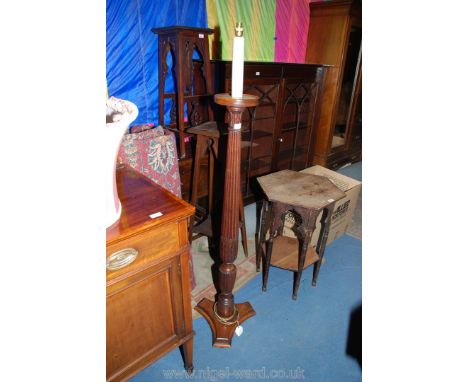 An ornate 1940's Oak Standard Lamp with faux candle bulb holder on a circular dish top with the turned, carved and reeded tap