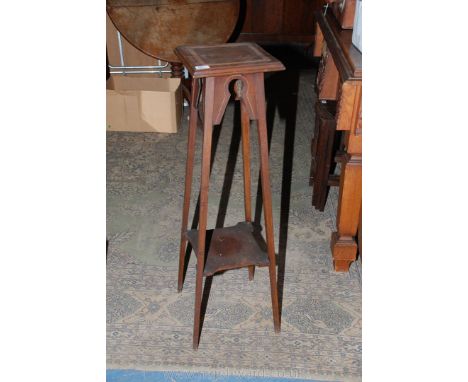 An Edwardian Mahogany Pot Stand with moulded square top and lighter wood inlaid band, fret-cut frieze and on long square tape