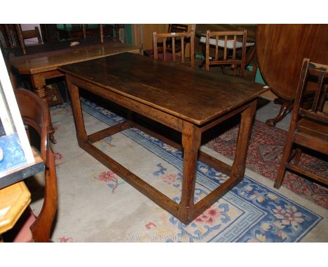 A late 17th early/18th c. Oak Dining Table, the three plank top being on a moulded frieze on stop chamfered square legs with 