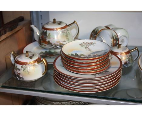 An oriental Teaset including four cups, six saucers and tea plates, teapot, lidded sugar bowl, lidded milk jug, and bread/but