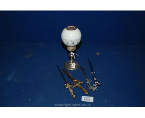 A Swiss Globe Timepiece 'Tempus Fugit' and three letter openers in silver and gilt colours.