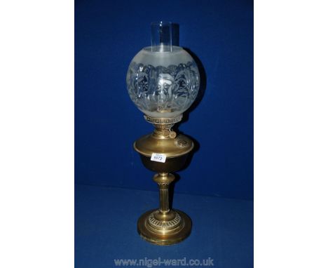 A Brass Oil Lamp with brass column and glass shade.