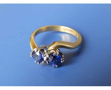 A two stone sapphire crossover set 18ct ring.