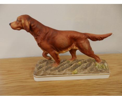 A Royal Worcester matt glazed Irish Setter by Doris Lindner, 7.75” across.