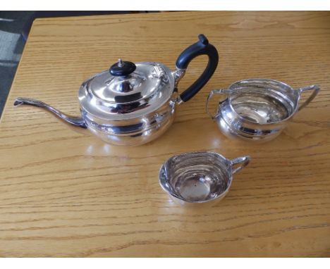 A three piece bachelor's crested silver tea service – SB&amp;S Ltd, Birmingham 1917.