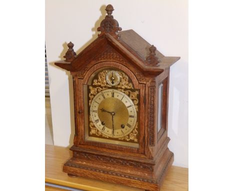 A 19thC oak cased mantel clock with brass dial, ting-tang striking on a gong, 18” high.