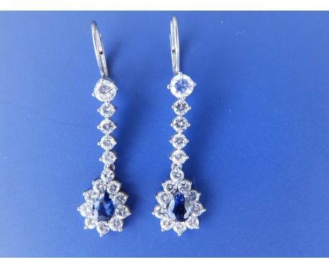 A pair of sapphire &amp; diamond set drop earrings of pendeloque shape in white metal, 1.25" overall.