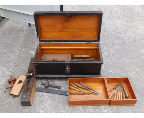 A wooden tool box with carpenter's tools.