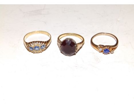 Two small sapphire &amp; diamond rings and a 22ct gold red stone ring. (3)