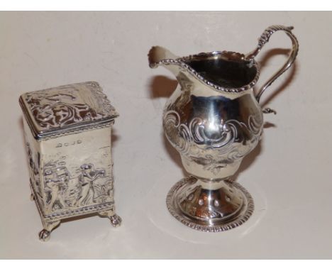 A George III embossed silver cream jug – London 1774 and a Birmingham silver square caddy – caddy a/f. (2)