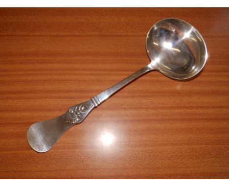 A Danish white metal soup ladle.