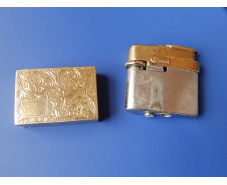 A plated Manshaw lighter sliding into 9ct gold base.