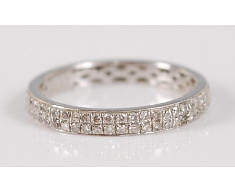 A contemporary 18ct white gold diamond eternity ring, arranged as two rows of pavé set diamond points, total diamond weight s