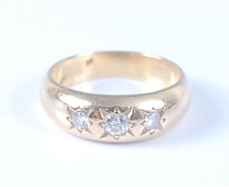 A yellow metal Gypsy set diamond dress ring, having three graduated old European cut diamonds in star settings, diamond dimen